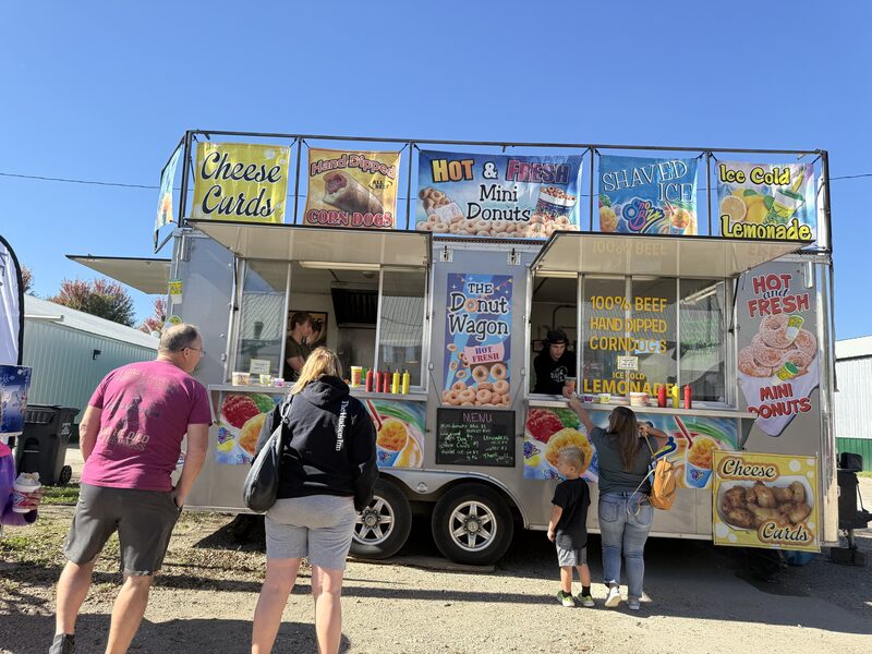 Festival goers ordering from The Donut Wagon food truck at Prairie Harvest Fest